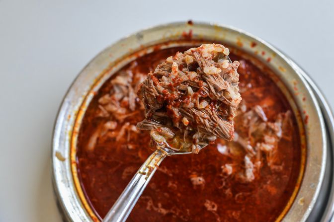 A breakfast favorite from the food-obsessed city of Gaziantep in eastern Turkey, this dish features lamb so tender it disintegrates into shreds alongside punches of garlic and chilli. Bubbling lamb broth is poured over cooked lamb and rice before being thrown onto a flaming fire and served with lemon slices and more chili.