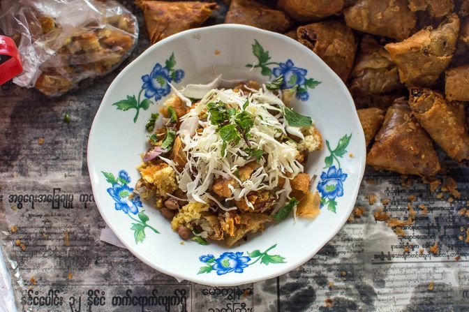 Yangon's best savory street food dish, say Zanzanaini and Petit. Reflecting Indian influences in Myanmar, the star of this dish is the potato and chickpea samosa. The crisp pastry of the samosa provides the crunch. Shredded cabbage, raw onions, mint and coriander bring out the freshness before thick masala lentil soup with a hint of cinnamon is ladled over it. 