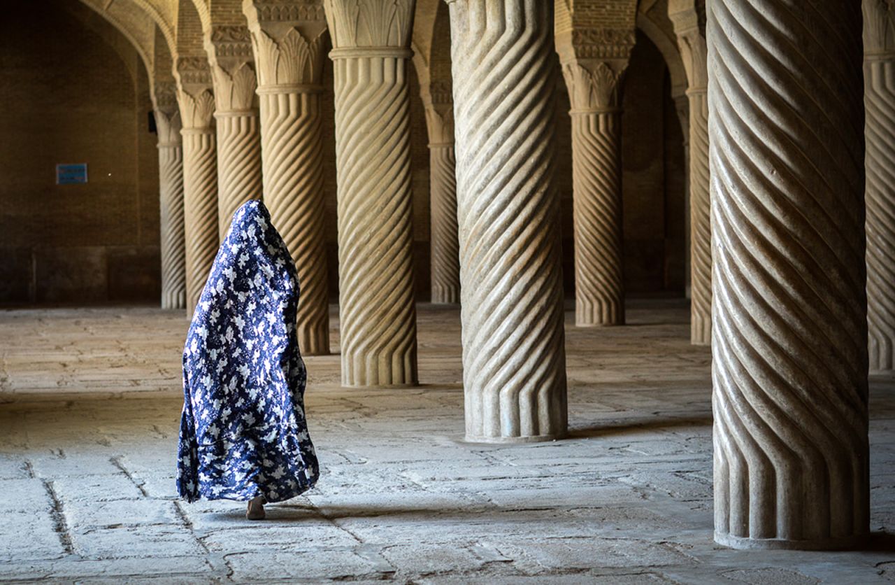 Zanzanaini wears a full chador as she tours the ancient corridors of Shiraz, Iran.