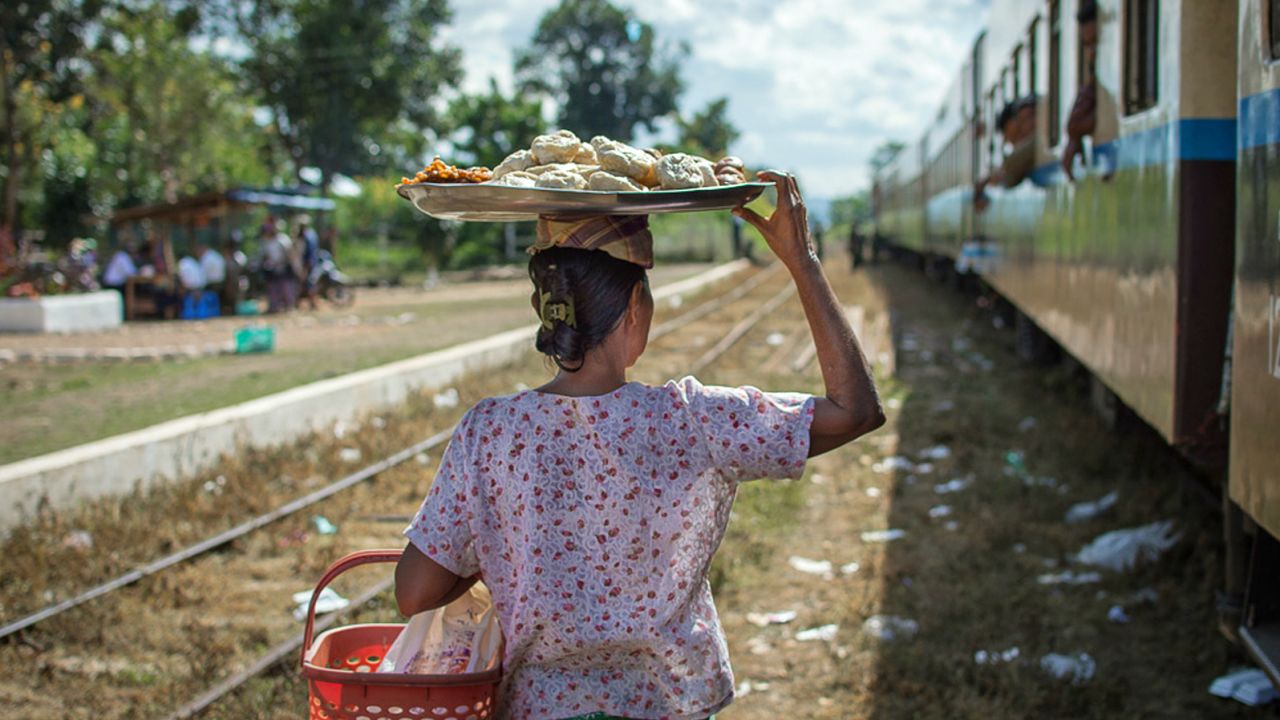 Women in Myanmar sell everything from steamed buns to fried noodles and boiled eggs from a platter balanced on their heads.