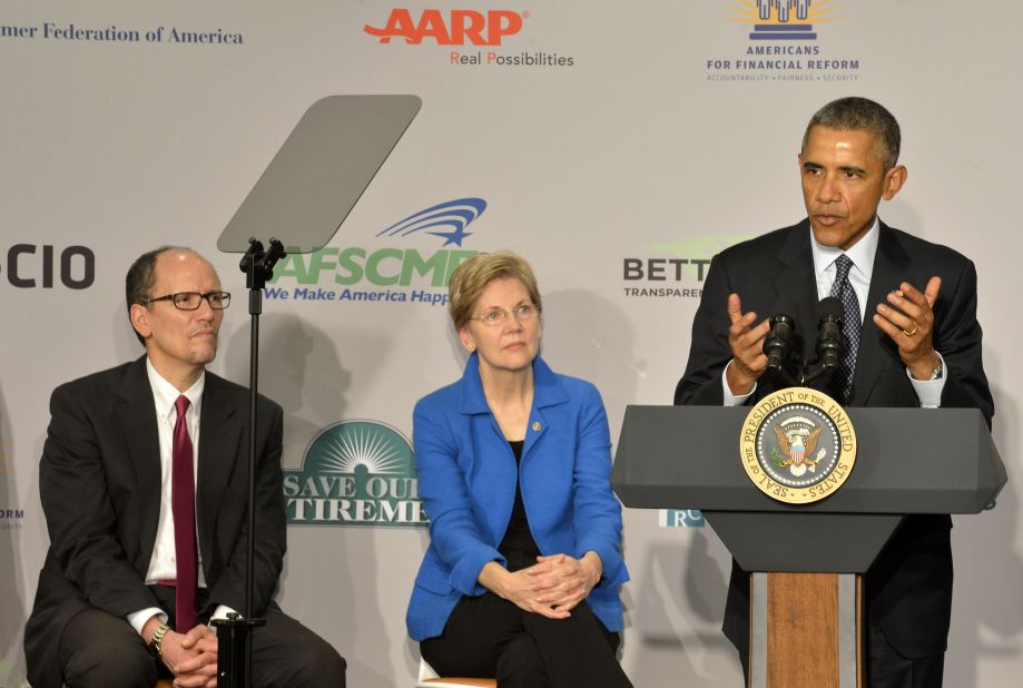 President Barack Obama (right) speaks as Warren and Labor Secretary Tom Perez listen at an AARP conference, February 23, 2015 in Washington, D.C. 