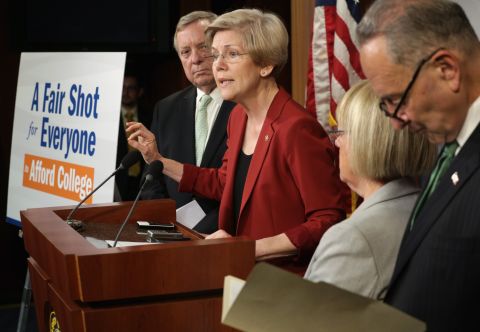 Warren (2nd from left) speaks as Senate Majority Whip Sen. Richard Durbin, D-Illinois, (left), Sen. Patty Murray, D-Washington, (3rd from left) and Sen. Chuck Schumer, D-New York, (right) listen during a news conference on college affordability on June 5, 2014, on Capitol Hill.