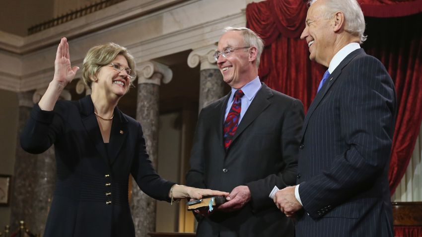 Senator Warren (Left) participates in a ceremonial swearing-in with her husband Bruce Mann and Vice President Joe Biden in the Old Senate Chamber on January 3, 2013 in Washington, DC.