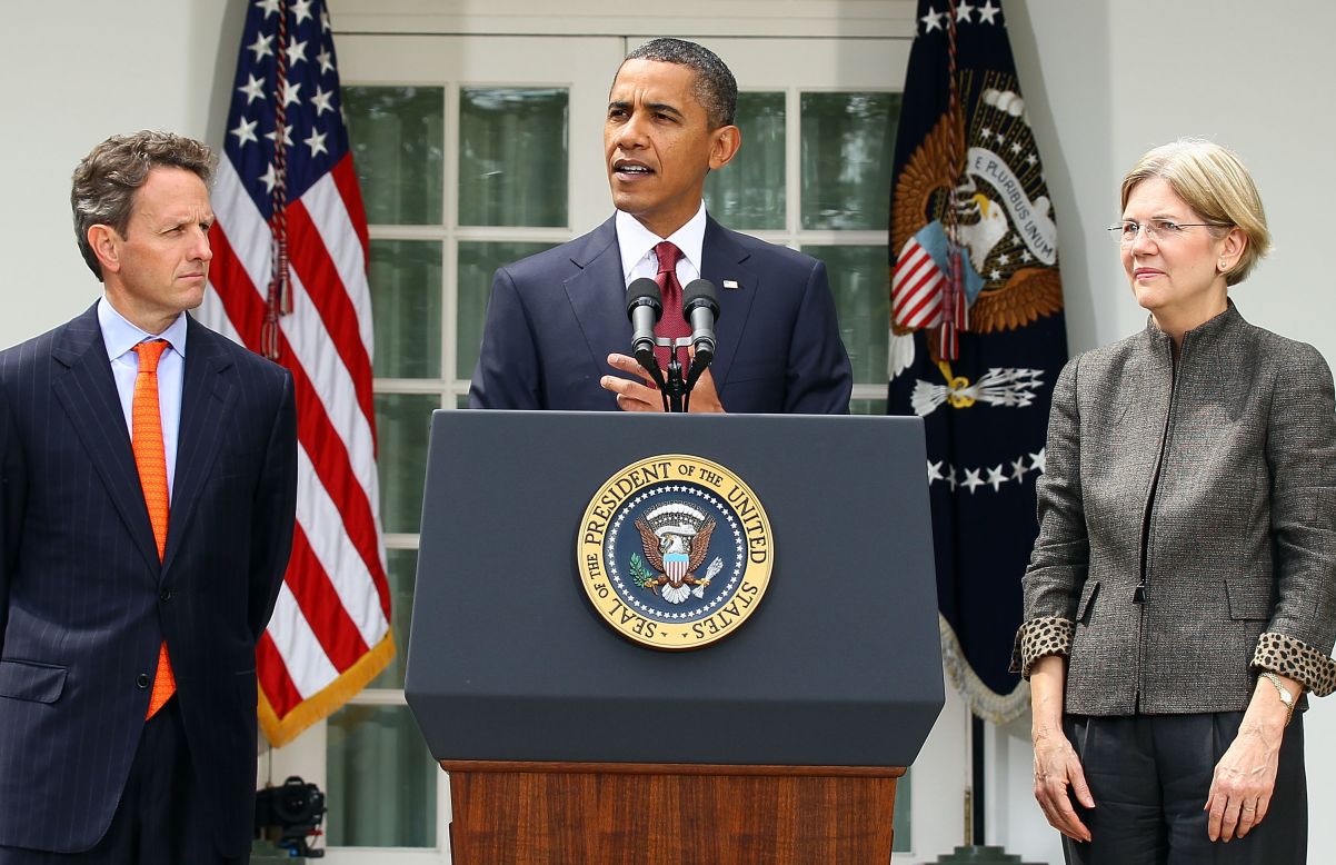 President Obama (center), with then-Treasury Secretary Timothy Geithner (left) looking on, appoints former Congressional Oversight Panel Chair, Warren (right), to assistant and special adviser to the Secretary of the Treasury on the Consumer Financial Protection Bureau on September 17, 2010.