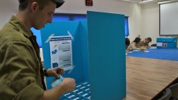 Caption:An Israeli soldier casts his vote at a Navy base in the Israeli port city of Haifa, on March 15, 2015, as military personal started to vote two days ahead of the March 17 general election. AFP PHOTO / GIL COHEN-MAGEN (Photo credit should read GIL COHEN MAGEN/AFP/Getty Images)