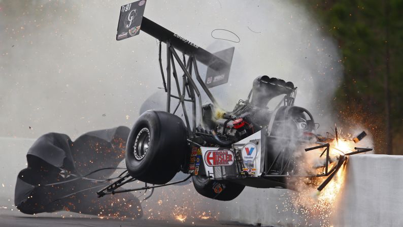Drag racer Larry Dixon crashes into the wall during the Gatornationals event Saturday, March 14, in Gainesville, Florida. The car broke in half, but Dixon walked away from the incident.