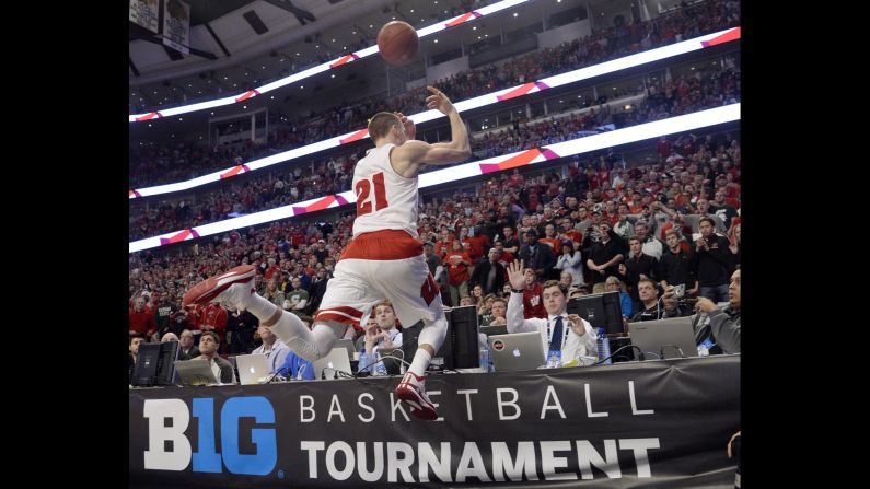 Wisconsin guard Josh Gasser dives into press row to keep a loose ball inbounds during the Big Ten championship game Sunday, March 15, in Chicago. The Badgers defeated Michigan State 80-69 and were later named a No. 1 seed in the NCAA Tournament.