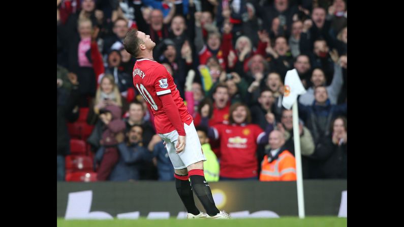Manchester United captain Wayne Rooney falls backward as he celebrates a goal Sunday, March 15, in Manchester, England. <a href="index.php?page=&url=http%3A%2F%2Fwww.cnn.com%2F2015%2F03%2F15%2Ffootball%2Ffootball-man-utd-tottenham-chelsea%2F" target="_blank">Rooney was making light of a recent video</a> that showed him getting knocked down while playfully boxing in his home.