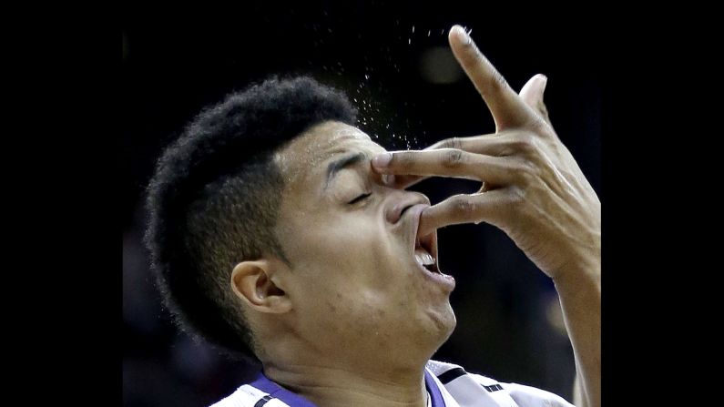 Kansas State's Justin Edwards catches an opponent's hand to the face while playing in a Big 12 tournament game Wednesday, March 11, in Kansas City, Missouri.