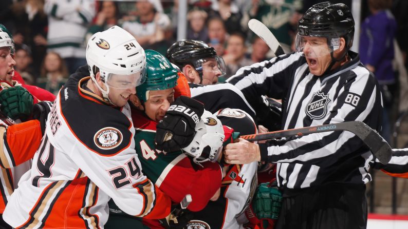 Linesman Mike Cvik tries to separate players during an NHL game in St. Paul, Minnesota, on Friday, March 13.