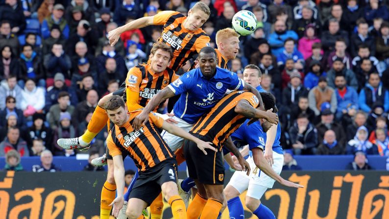 Players from Leicester City (blue) and Hull City compete for a header during a Premier League match in Leicester, England, on Saturday, March 14.