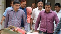 Indian policemen escort the juvenile (C, in pink hood), accused in the December 2012 gang-rape of a student, following his guilty verdict at a court in New Delhi on August 31, 2013. An Indian court found a teenager guilty August 31 over the fatal gang-rape of a student in New Delhi, a crime that sparked revulsion and angry protests in the country, an official said. AFP PHOTO/Prakash SINGH