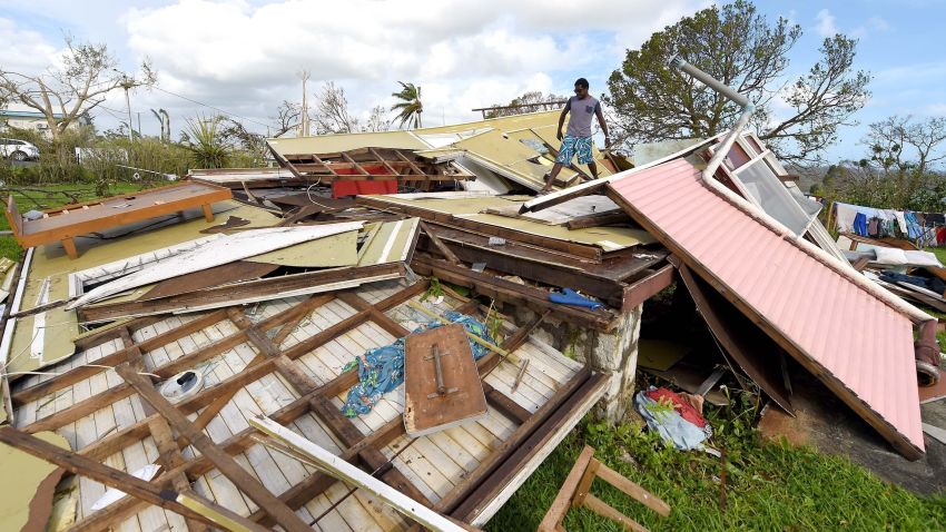 In this photo taken on March 16, 2015 a man looks through the ruins of his home in Vanuatu's capital Port Villa after Cyclone Pam ripped through the island nation. The UN said on March 17, 2015 that twenty-four people have been killed by Cyclone Pam, as the Pacific nation's president pleaded for help to rebuild the archipelago's "completely destroyed" infrastructure. AFP PHOTO / POOL / DAVE HUNTDAVE HUNT/AFP/Getty Images