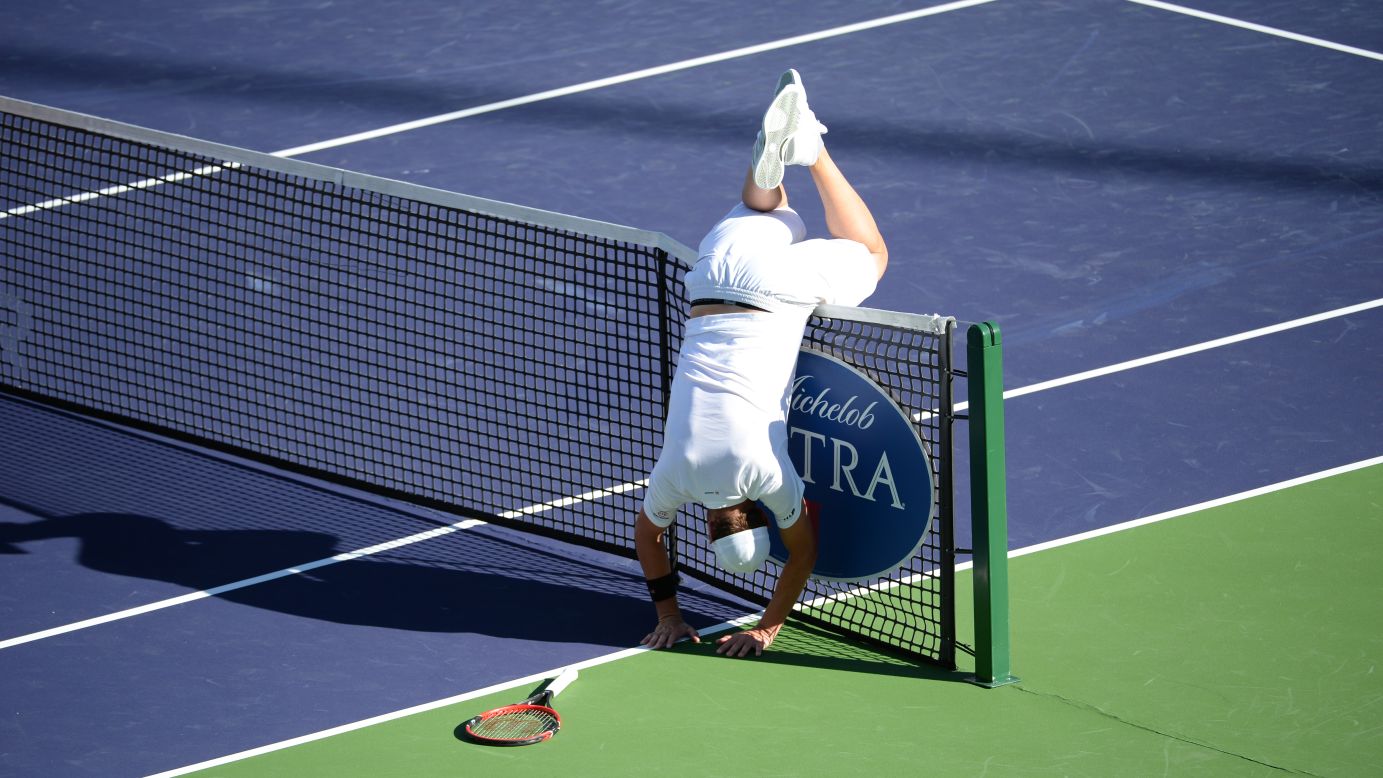 Mardy Fish flips over the net Thursday, March 12, after chasing down a ball during his first-round match at the BNP Paribas Open in Indian Wells, California.