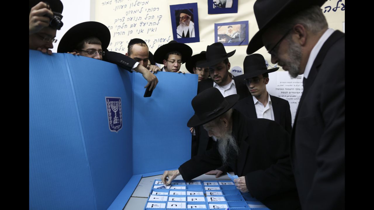 Rabbi Gershon Edelstein, center, prepares to vote in Bnei Brak, Israel, on March 17.