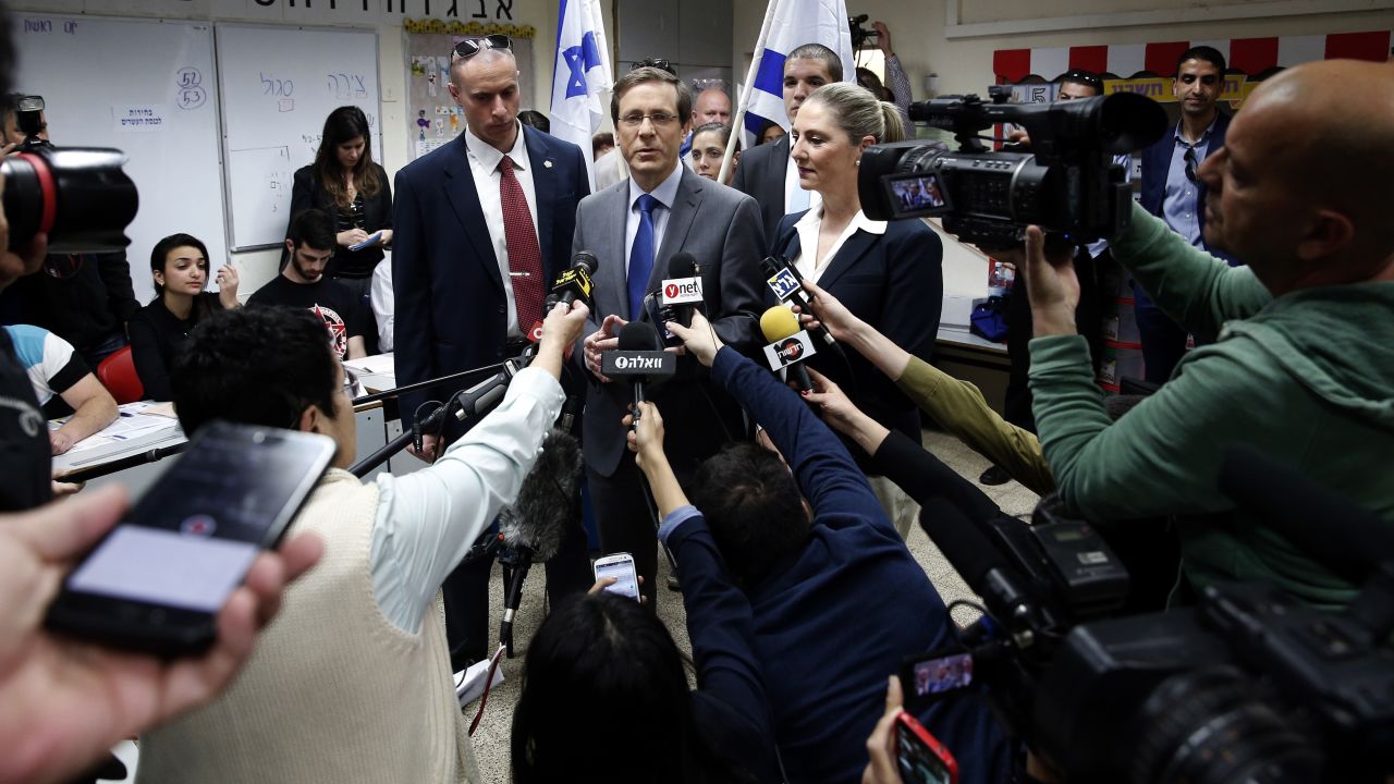 Herzog talks to the media after voting in Tel Aviv on March 17.