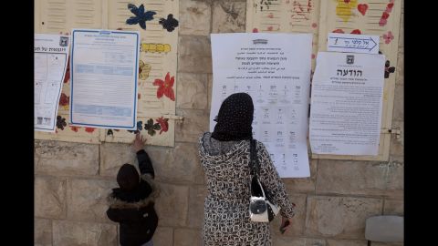 A woman and child stand outside a polling station in Abu Ghosh, Israel, on March 17.