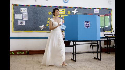 An Israeli bride prepares to cast her vote at a polling station in Holon, Israel, on March 17. 