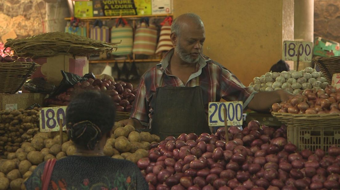 Market stalls sell local produce, catering to a variety of cultures that make up cuisine on the island. 