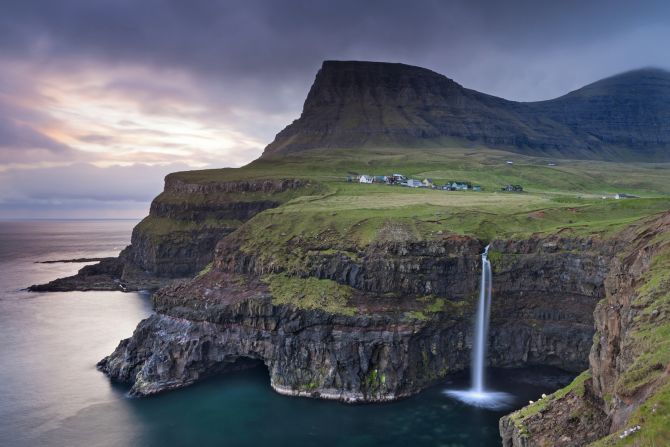 On the west side of Vagar, <a  target="_blank" target="_blank">Gasadalur</a> sits next to a stunning waterfall. Prior to a tunnel opening in 2004, the village's 16 residents had to hike or horseback over the steep mountain to reach the rest of the island.