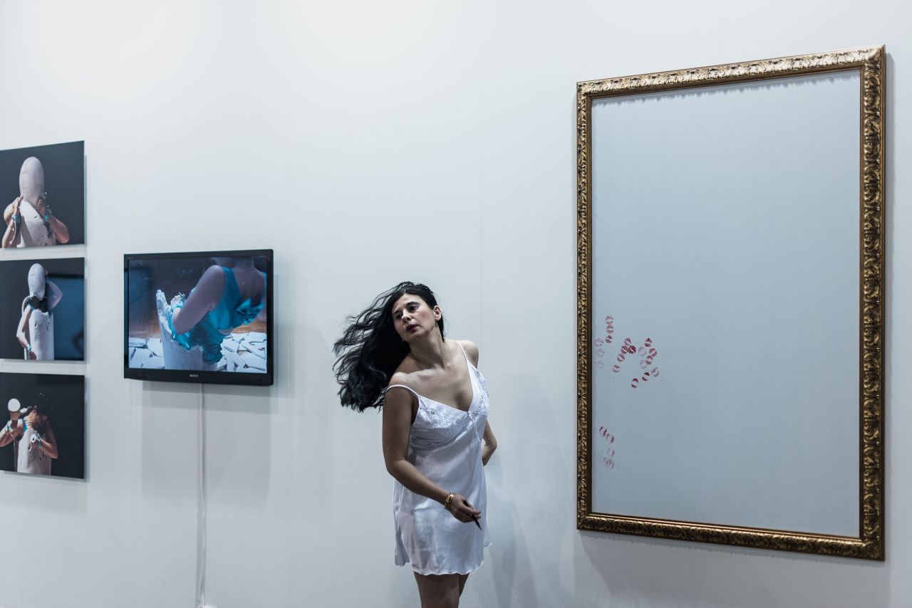German performance artist, Nezaket Ekici, uses lipstick kisses to create an artwork during the launch. 