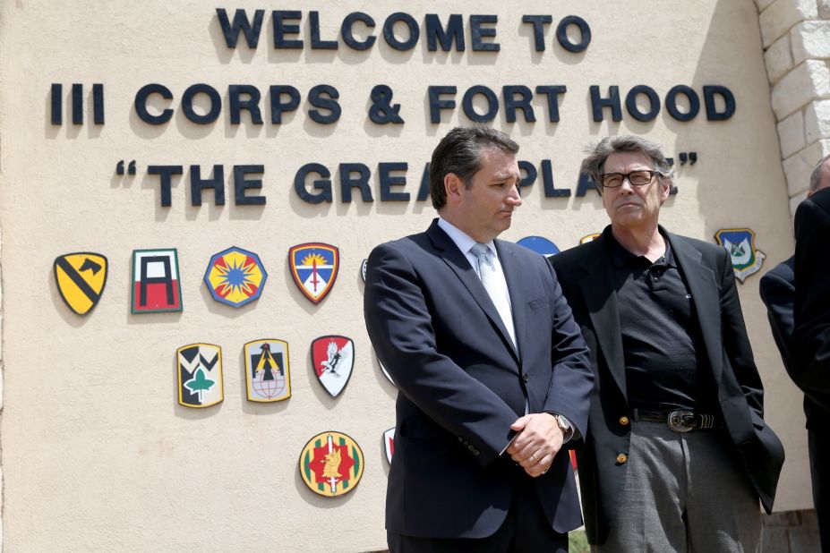 Cruz (left) and then-Texas Governor Rick Perry stand together during a press conference at the front gate of Fort Hood about Iraq war veteran, Ivan Lopez, who killed three and wounded 16 before taking his own life on April 4, 2014, in Fort Hood, Texas.