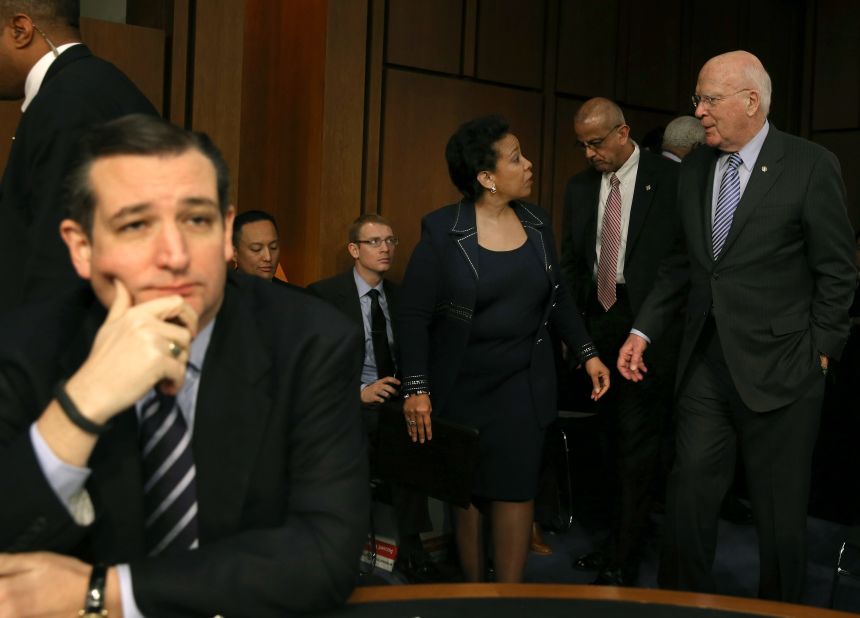 Sen. Patrick Leahy (right) escorts Loretta Lynch back from a lunch break as Cruz  (left) sits nearby during her confirmation hearing before the Senate Judiciary Committee January 28, 2015, on Capitol Hill.