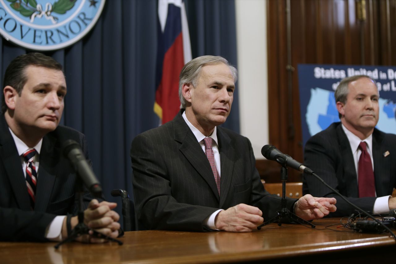 Governor Greg Abbott (center) speaks alongside Cruz (left), Attorney General Ken Paxton (right) at a joint press conference February 18, 2015, in Austin, Texas.
