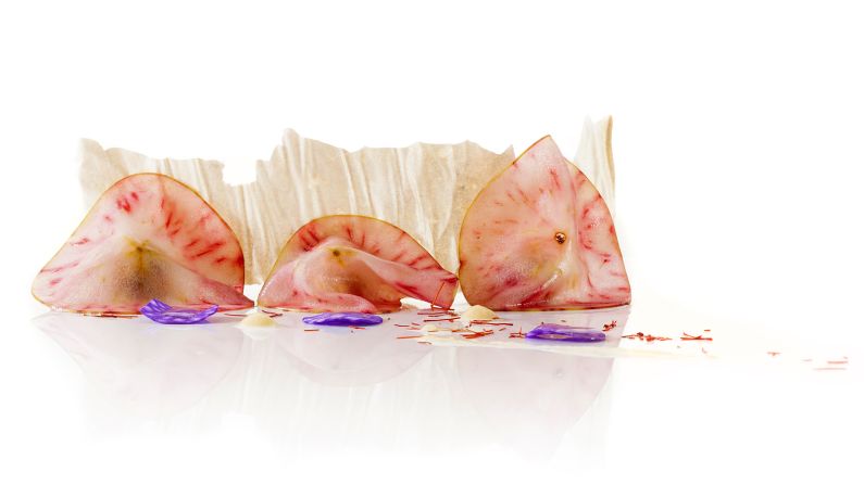 Paper thin slices of apple are infused with beetroot that surround foie gras covered in pistachio and almond. Crispy potato "mother of pearl" shards complete the dish.