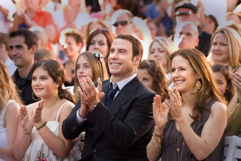 Actor John Travolta and his wife, actress Kelly Preston, attend the opening of a Scientology Mission in Ocala, Florida, in May 2011.
