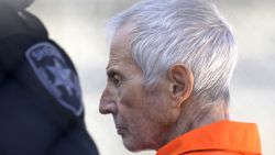 Robert Durst is escorted into Orleans Parish Prison after his arraignment in Orleans Parish Criminal District Court in New Orleans, Tuesday, March 17, 2015.  Durst was rebooked on charges of being a convicted felon in possession of a firearm, and possession of a weapon with a controlled dangerous substance.   (AP Photo/Gerald Herbert)