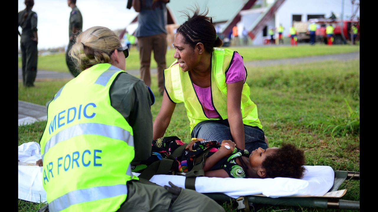 Australian doctors help a young girl on the Vanuatu island of Tanna on Wednesday, March 18.