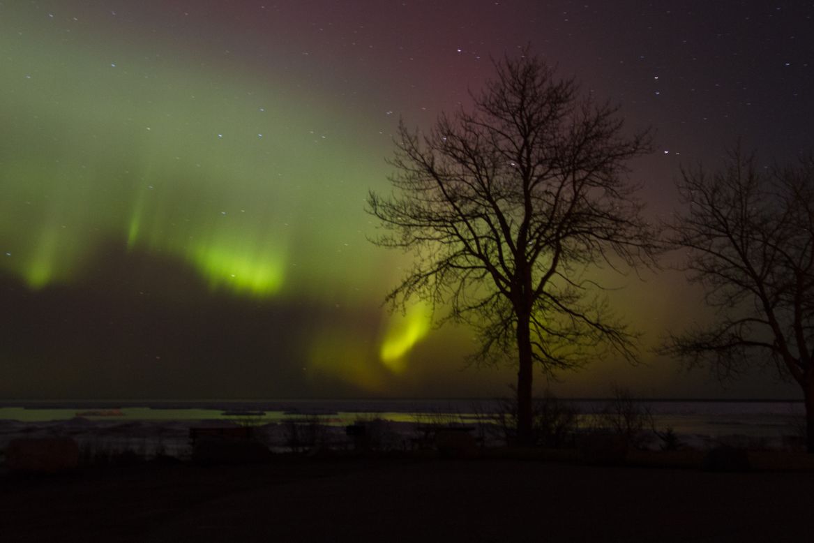 The northern lights cascade across Lake Huron in northern Michigan on Tuesday evening. 