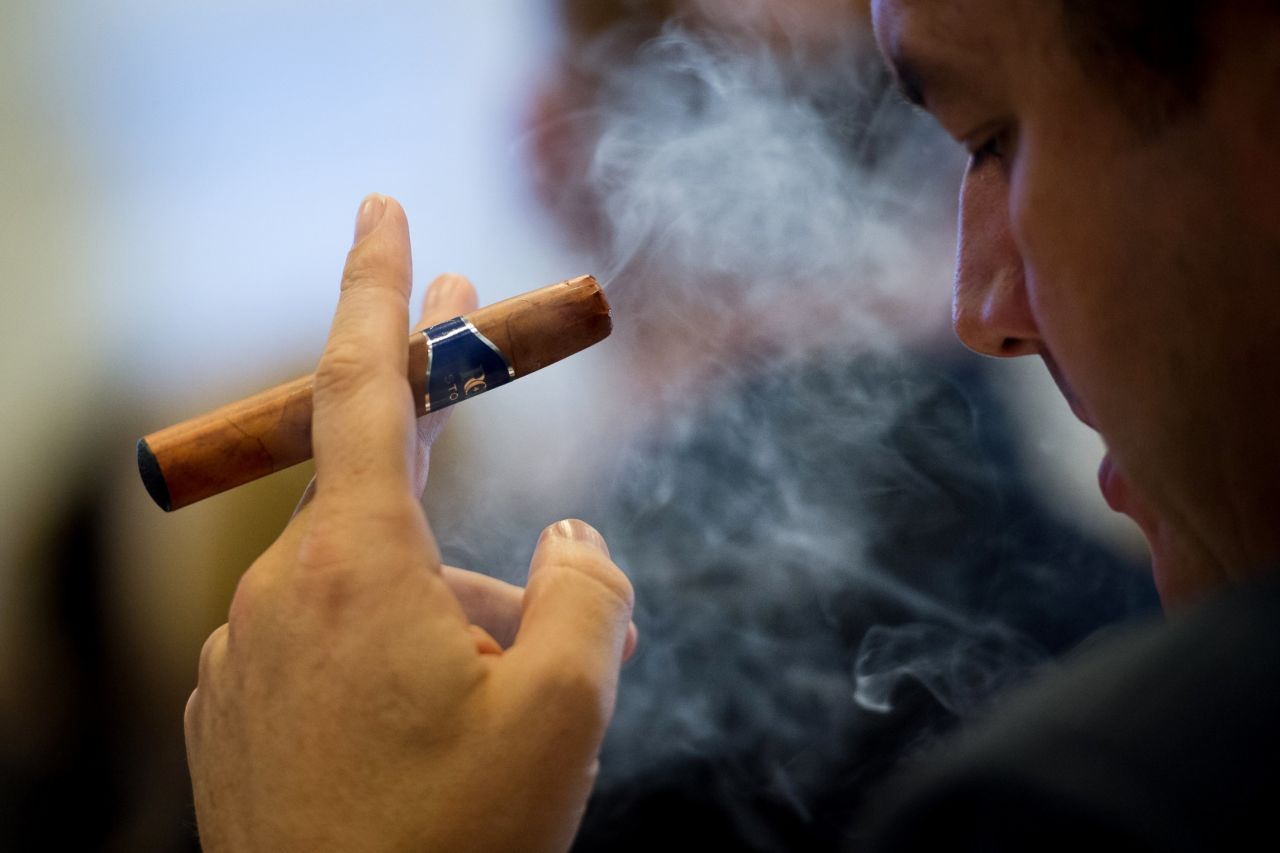 A delegate at the "E-Cigarette Summit" smokes an e-cigar. In the e-liquid, nicotine is usually suspended in propylene glycol and glycerine.