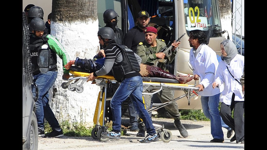 A person is taken away on a stretcher outside the museum. 