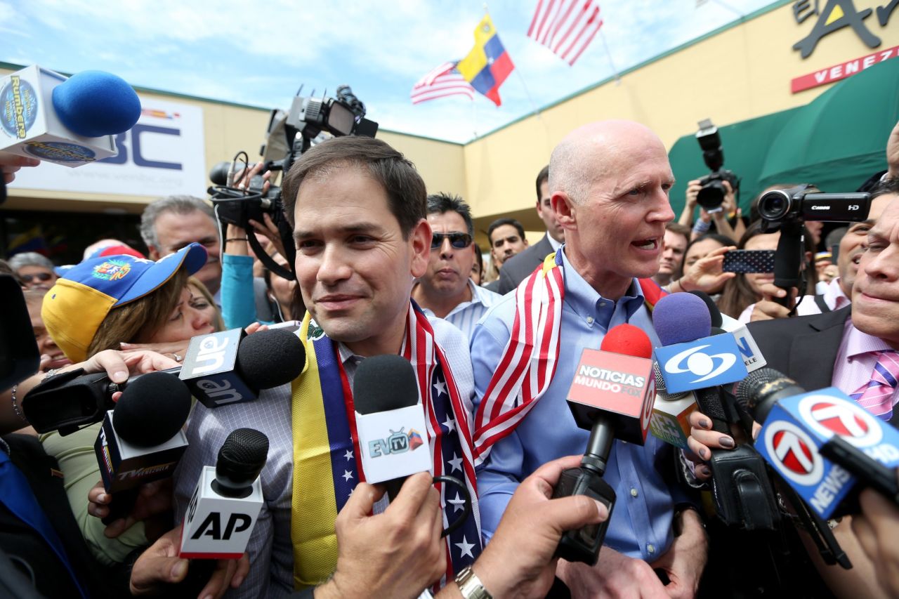 Rubio, left, and Florida Gov. Rick Scott speak to the media in Doral in February 2014.