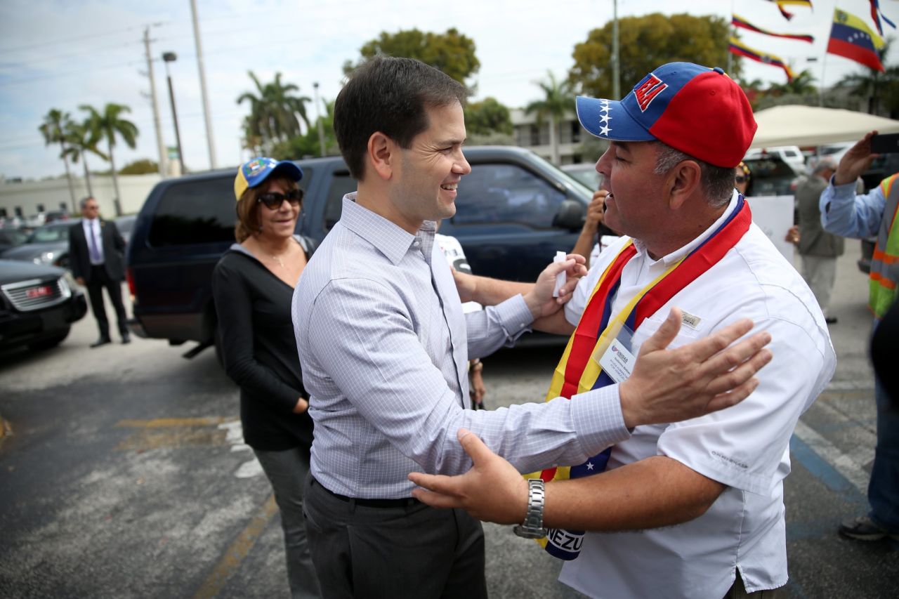 Rubio, left, is greeted as he arrives at a restaurant in Doral in February 2014.