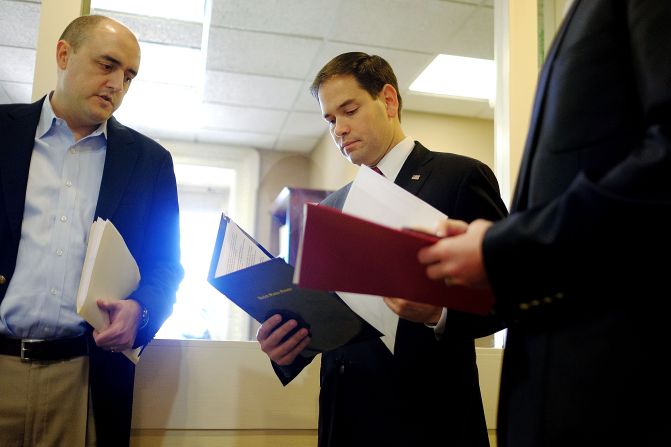 Rubio talks to aides in December before speaking on President Barack Obama's announcement about revising policies on U.S.-Cuba relations.