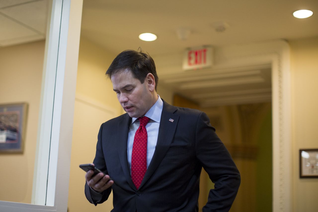 Rubio checks his phone in March as he arrives for a Capitol Hill news conference to introduce a proposal for an overhaul of the tax code.