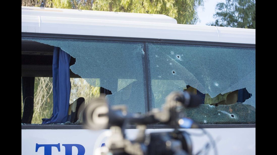 Bullet holes are seen in a bus window near the museum.