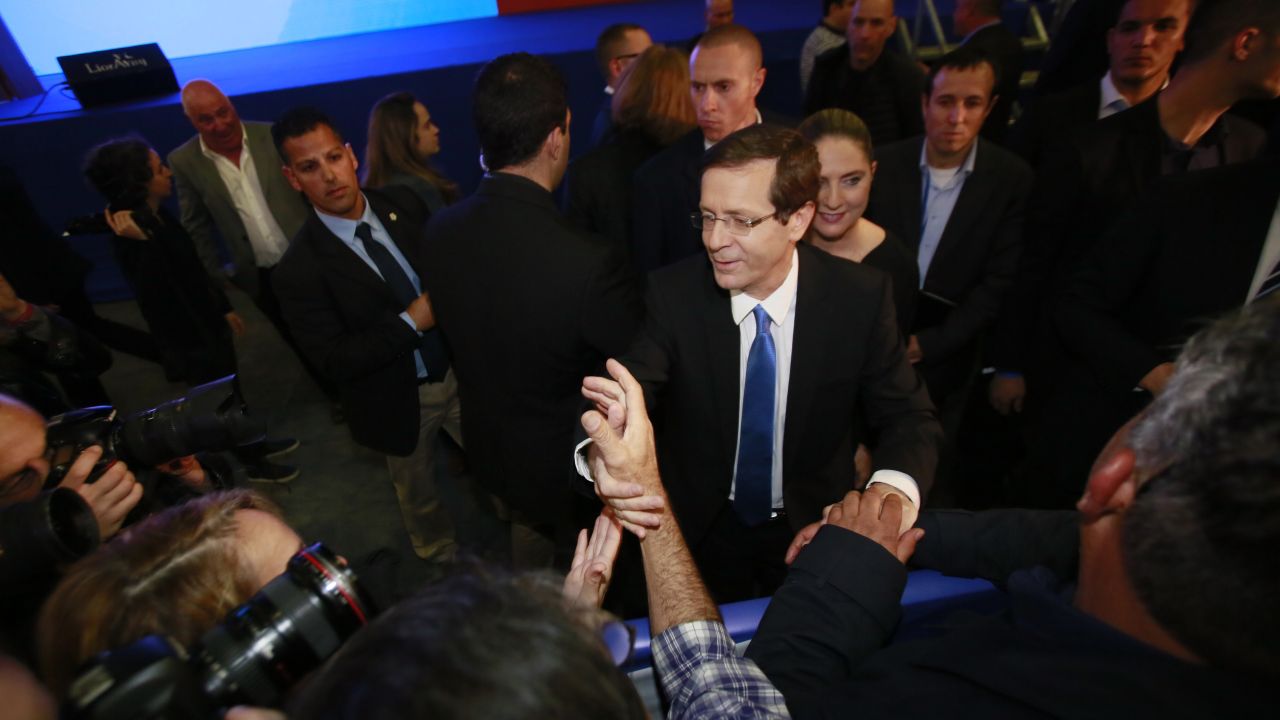 Isaac Herzog, co-leader of the Zionist Union alliance, shakes hands with supporters in Tel Aviv as he reacts to exit poll figures on Tuesday, March 17.