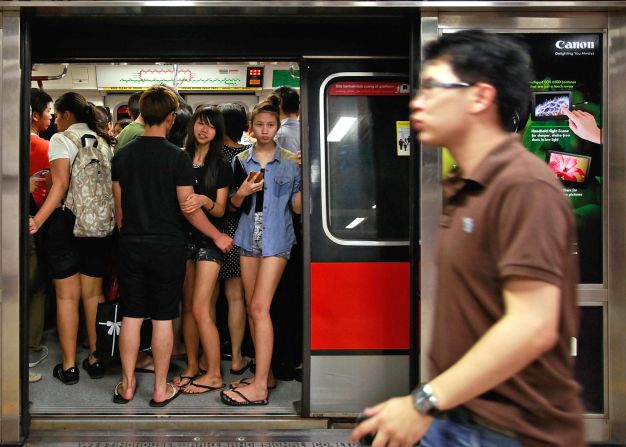 Commuters stand inside a train in the Tanjong Pagar MRT station during rush hour at the central business district area. 