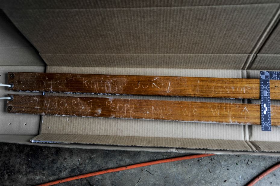 Prosecutors said these boards were attached to the boat where police found Dzhokhar Tsarnaev hiding. A carved message reads, "Stop killing our innocent people and we will stop."