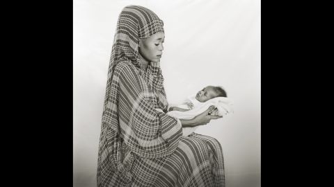 Johahir Zakaria, 17, holds her baby daughter.