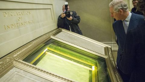 Charles looks at the Declaration of Independence during a visit to the National Archives in Washington on March 18.