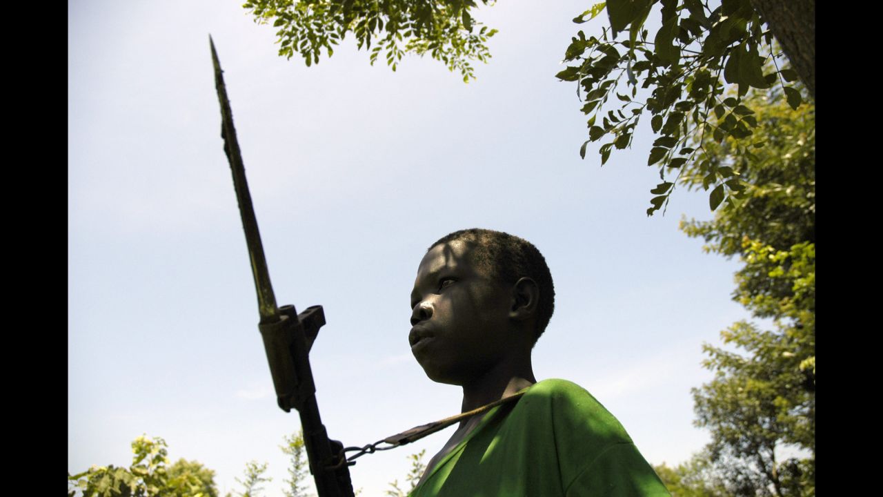 A young boy fighting for the Lord's Resistance Army stands guard in South Sudan as LRA leader Joseph Kony meets with the Southern Sudan vice president in July 2006. 