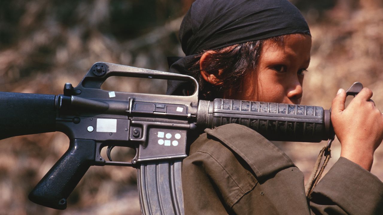 A 12-year-old soldier in Kamerplaw, southern Myanmar, at the headquarters of God's Army, in 2001. God's Army was a breakaway guerrilla faction of the Christian Karen National Union. 
