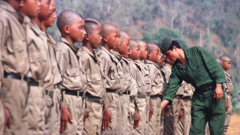 Child soldiers of the resistance Mong Tai Army during training with their commander in Myanmar in 2001. 
