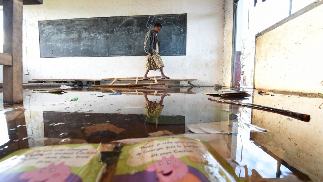 A child walks through a damaged classroom on Tanna Island on March 19.