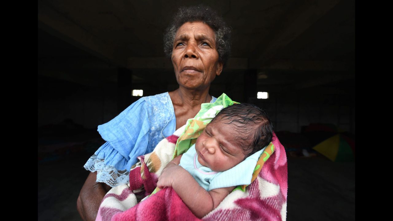 Mercy Watskal holds her week-old granddaughter, Angelina, at the Enima Evacuation Center on Tanna Island on March 19.